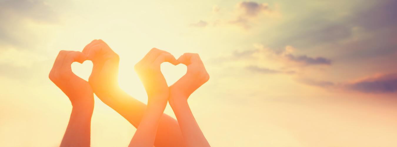 hand silhouette creating heart