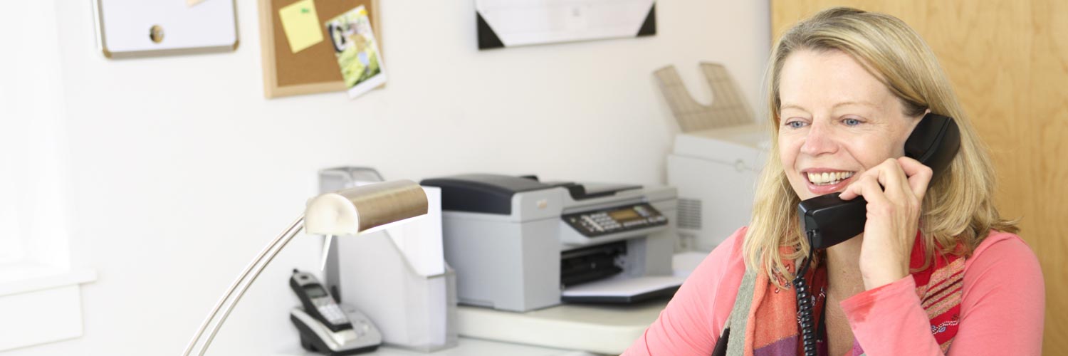 woman talking on corded phone